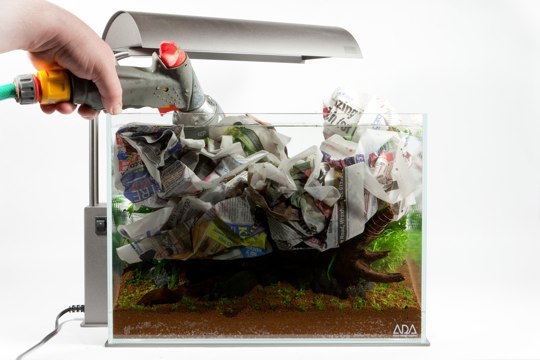 ADA Mini M Nature Aquarium Step-by Step Photo - Newspaper is temporarily added to the scape to help stop clouding when filling with water. 